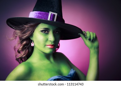 Halloween green witch on a pink background