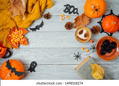 Halloween Holiday Background With Coffee Cup, Pumpkin And Autumn Leaves On Wooden Table. Top View From Above. Flat Lay