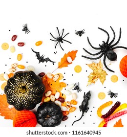 Halloween Holiday Background With Colorful Candy, Bats, Spiders, Pumpkins And Decorations. Flat Lay. View From Above