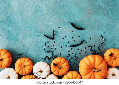 Halloween Holiday Card With Party Decorations Of Pumpkins And Bats On Blue Table Top View. Happy Halloween Greeting Poster In Flat Lay Style.