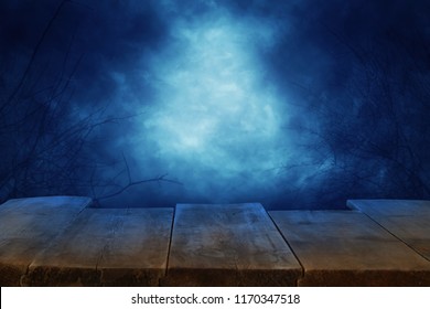 Halloween Holiday Concept. Empty Rustic Table In Front Of Scary And Misty Night Sky Background. Ready For Product Display Montage