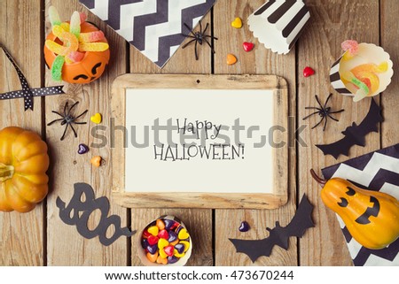 Halloween holiday poster mock up template with pumpkin and candy. View from above