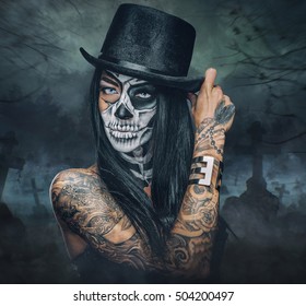 Halloween holidays. Close up portrait of female with skull make up.