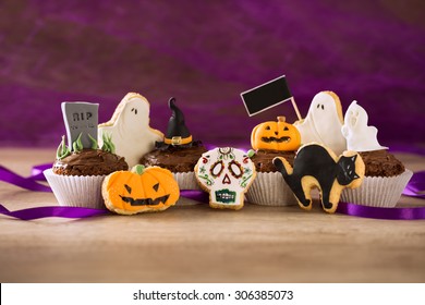 Halloween Homemade Scary Cookies And Cupcakes On Purple Spider Background