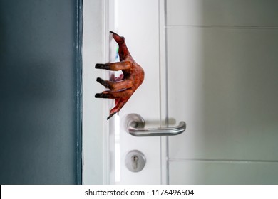 Halloween horror concept. Image of a creepy hand emerging from the open house door