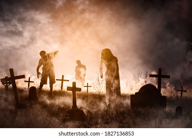 Halloween Horror Concept. Three Creepy Ghost Walking In The Misty Graveyard After Rising Out Of The Ground