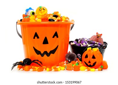 Halloween Jack o Lantern candy bowls with assorted candy over white - Powered by Shutterstock