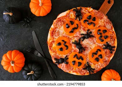 Halloween Jack O Lantern Pizza. Above View Table Scene On A Dark Background With Pumpkins.