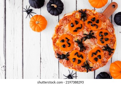 Halloween Jack O Lantern Pizza. Above View On A White Wood Table Background With Pumpkins. Copy Space.