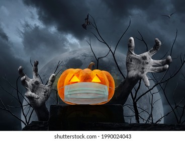 Halloween Jack O Lantern Pumpkin Wearing Medical Face Mask On Rock With Zombie Hand, Bat, Bird, Dead Tree Over Full Moon And Spooky Cloudy Sky, Halloween And Coronavirus Or Covid-19 Concept