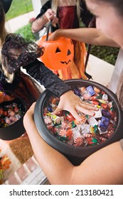 Halloween: Kids Reaching In For Trick Or Treat Candy