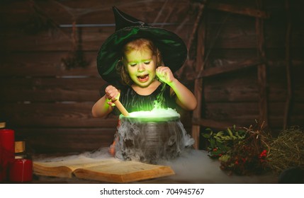 Halloween. Little Witch Child Cooking Potion In The Cauldron With Spell Book
