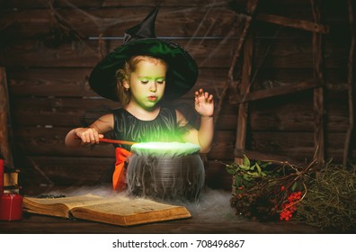 Halloween. Little Witch Child Cooking Potion In The Cauldron With Spell Book
