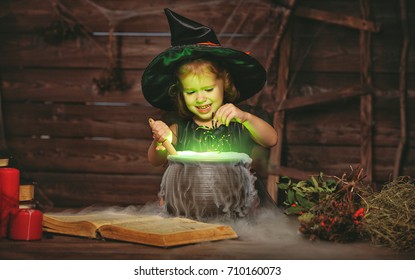 Halloween. Little Witch Child Cooking Potion In The Cauldron With Spell Book
