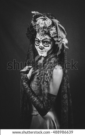 halloween make up sugar skull beautiful model with perfect hairstyle. Santa Muerte concept. Fashion retro toning.