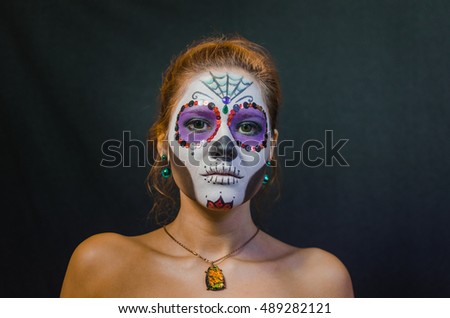 halloween make up sugar skull beautiful model with perfect hairstyle. Santa Muerte concept. Fashion retro toning.
