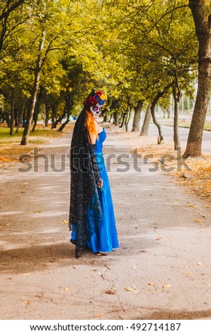 halloween make up sugar skull beautiful model with perfect hairstyle. Santa Muerte concept. Fashion retro toning. walks in the Park - the field