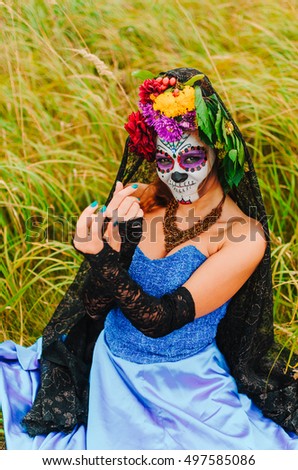 halloween make up sugar skull beautiful model with perfect hairstyle. Santa Muerte concept. Fashion retro toning. walks in the Park - the field
