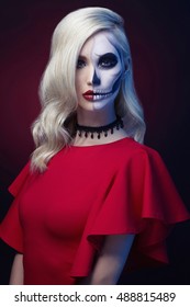 halloween make-up skull beautiful woman with blond hairstyle. Santa Muerte model girl in red dress