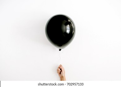 Halloween Minimal Concept. One Black Balloon In Girl's Hand. Flat Lay, Top View.
