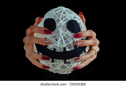 Halloween Mummy In Female Hands Isolated On Black Background. Spirit And Supernatural. White Face With Spooky Smiley And Manicure With Gems. Nail Art Concept. Holiday And Party Celebration.