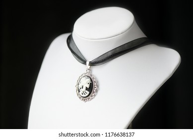 Halloween Necklace With Skeleton Cameo Pendant On A Dark Background Close Up