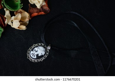 Halloween Necklace With Skeleton Cameo Pendant On A Dark Background Close Up