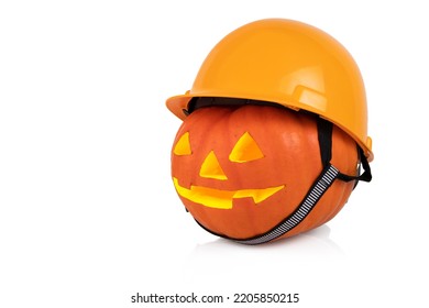 Halloween, orange pumpkin with yellow construction helmet, hard hat. White background.