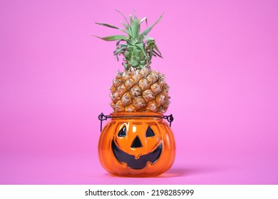 Halloween Parody Funny Pineapple In Halloween Candlestick. Treat Dessert Fruit For Trick Or Treating, Sweetness Or Nasty. Decoration For All Saints Day Exotic Fruits In A Scary Stand