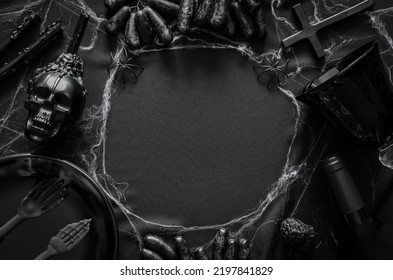 Halloween Party Concept With Black Deco Accessories, A Bottle And Glass Of Wine, Grape Fruits And Cobweb Put On Cloth Background.