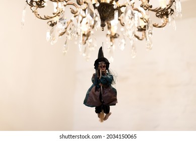 Halloween Party Decorations. Preparation For The Holiday. Witch On A Chandelier 