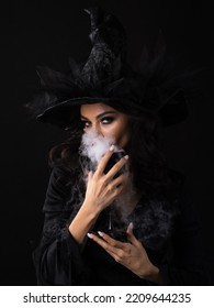 Halloween Party Woman In Witch Costume Holding Goblet Of Potion Drink With Smoke