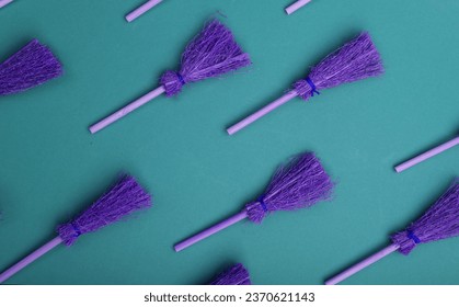 Halloween pattern with witch brooms on blue background