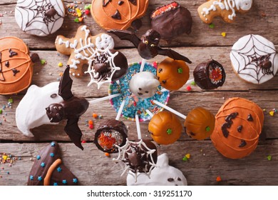 Halloween Pop Cakes And Gingerbread Cookies On The Table. Horizontal View From Above
