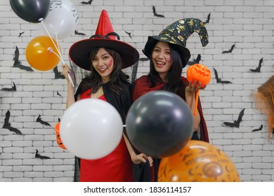 halloween portrait of two women in halloween witches costume with balloon - Shutterstock ID 1836114157