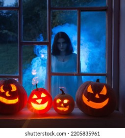 Halloween Pumpins On Windowsill With Ghost Outside  Window