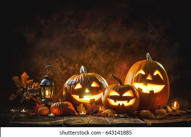 Halloween pumpkin head jack lantern and burning candles
