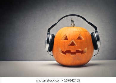 Halloween pumpkin with headphones for music