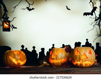 Halloween Pumpkin On Wooden Planks. Cemetery Grave Stones On Background