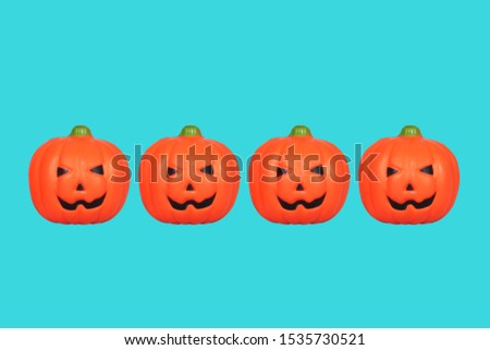 Halloween Pumpkin Toys on lined up on blue background./Halloween Concept
