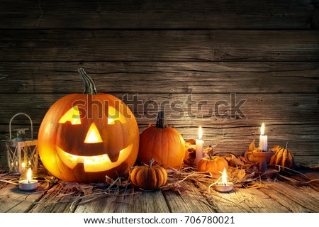 Halloween Pumpkins And Candles On Wooden