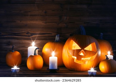 Halloween pumpkins with cut faces and candles dark holiday card