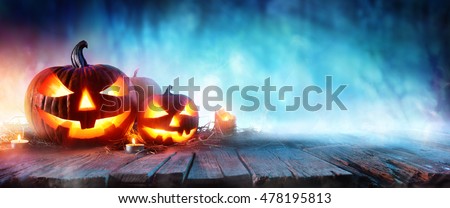 Halloween Pumpkins On Wood In A Spooky Forest At Night
