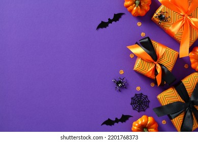 Halloween Sale Concept. Flat Lay Composition With Gift, Boxes, Pumpkins, Spiders, Bats, Confetti On Purple Table. Halloween Discount, Special Offer Banner Design.