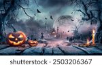 
Halloween Scene - Pumpkin On Table In Cemetery At Moonlight - Contain Unrecognizable, Deformed And Defocused Church With Reassembled Part