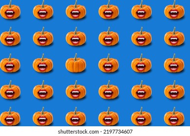 Halloween Seamless Pattern. Bloodthirsty Pumpkins With A Vampire Smile On A Blue Background. Holiday Concept.