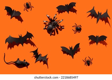 Halloween splash screen black paper bats, spiders, tarantula, mouse with hard shadows on orange background. Halloween decoration with your own hands in gothic style, holiday decoration mockup.