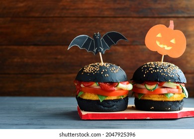 Halloween Spooky Black  Burger. Cheeseburger On Halloween Pumpkin Head Jack Lantern Holiday Food Background	