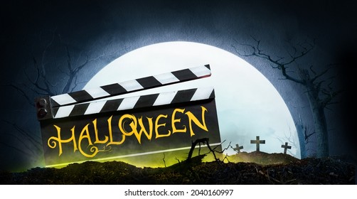 Halloween. Text title on film slate or movie clapperboard. The full moon on Graveyard silhouette Abstract Background.