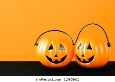 Halloween Theme With Pumpkin Buckets On Orange And Black Background